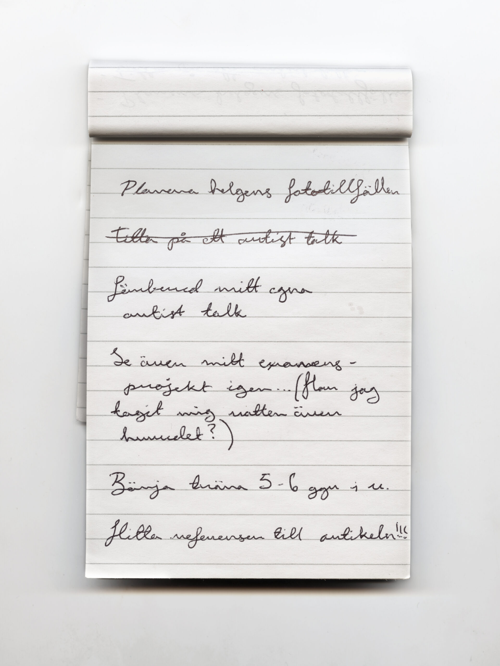 A notepad with a written to-do list on